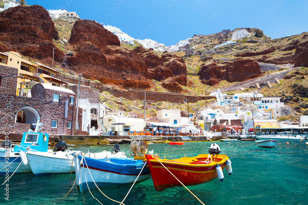 Old port of Oia village at Santorini island in aegean sea, Greece.