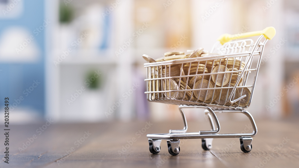 Miniature shopping cart full of coins Miniature shopping cart full of coins