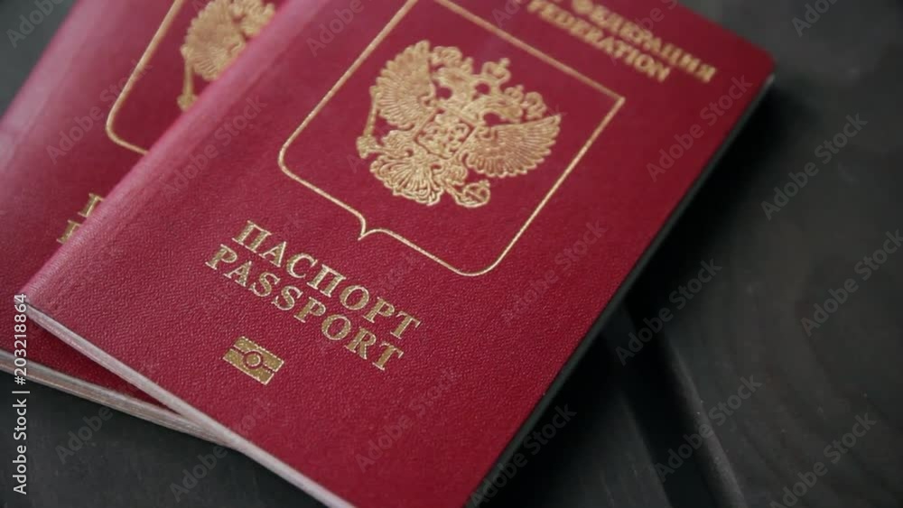 Hands putting the passport of Russian federation