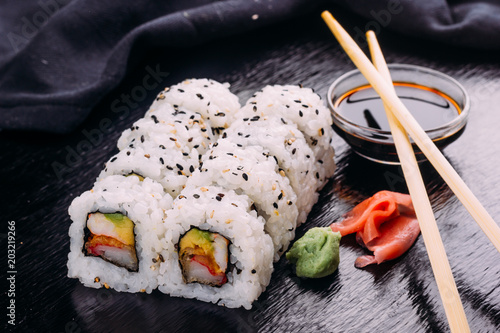 Sushi roll served with wasabi and ginger