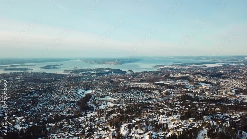 Aerial winter shot of Holmenkollen, Oslo and Oslo fjord seen from the hills behind Oslo city in Norway Aerial winter shot of Holmenkollen, Oslo and Oslo fjord seen from the hills behind Oslo city in Norway