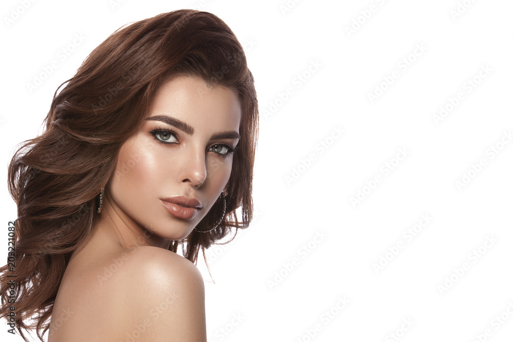 Beauty portrait of a young girl with natural make-up and natural lip color. Hairstyle curls, chestnut hair color. White isolated background. Beauty portrait of a young girl with natural make-up and natural lip color. Hairstyle curls, chestnut hair color. White isolated background.