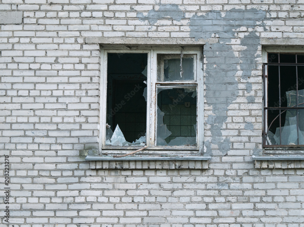 Abandoned brick building with broken window Abandoned brick building with broken window