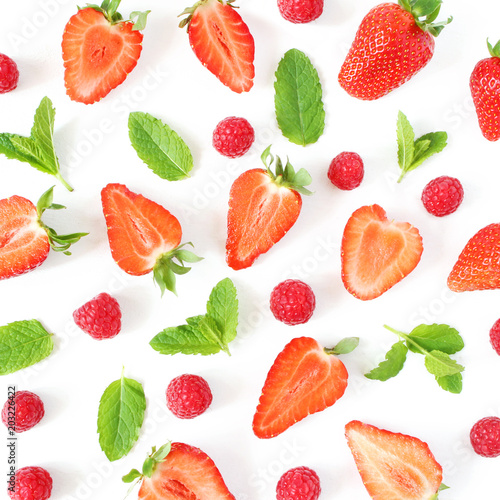 Fototapeta Naklejka Na Ścianę i Meble -  Styled stock photo. Summer healthy fruit composition with sliced strawberries, raspberries, fresh green mint leaves isolated on white wooden table background. Food pattern. Flat lay, top view, square