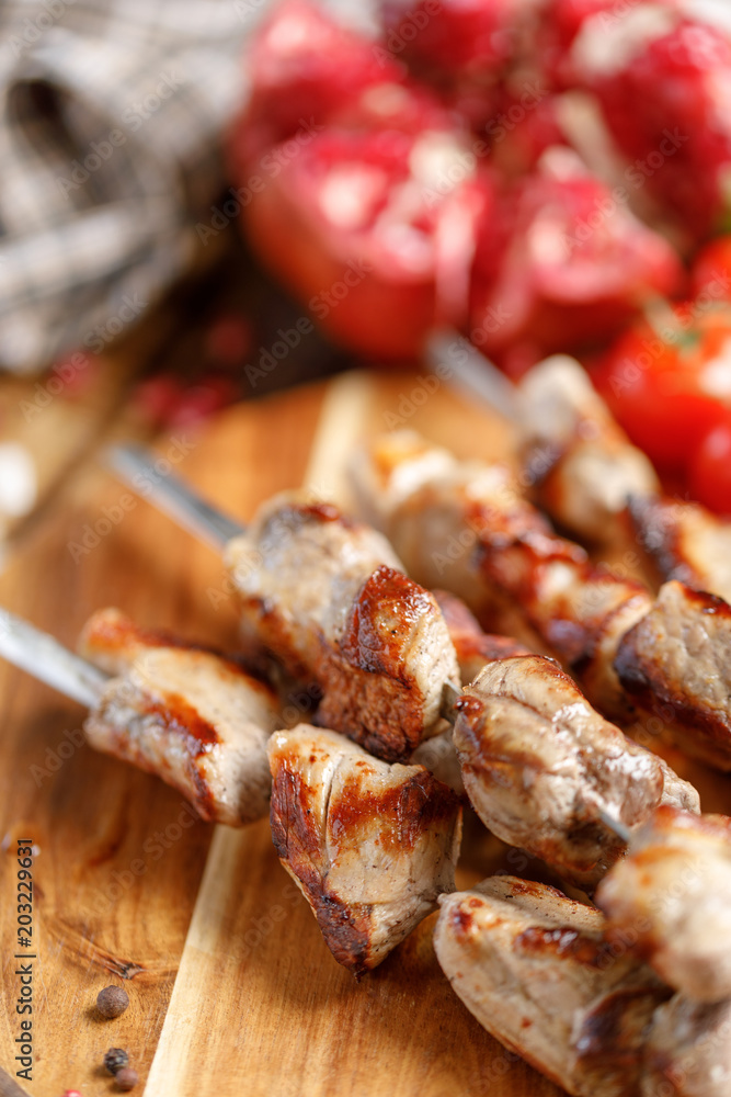 Shish kebabs from pork on skewers close-up. Juicy appetizing meat cooked on an open fire. Rustic. Shish kebabs from pork on skewers close-up. Juicy appetizing meat cooked on an open fire. Rustic.