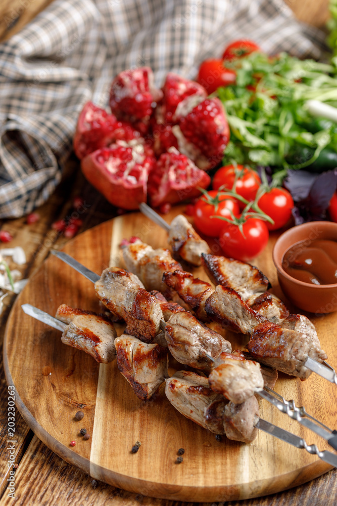 Shish kebabs on skewers close-up. Juicy appetizing meat cooked on an open fire. Rustic.
