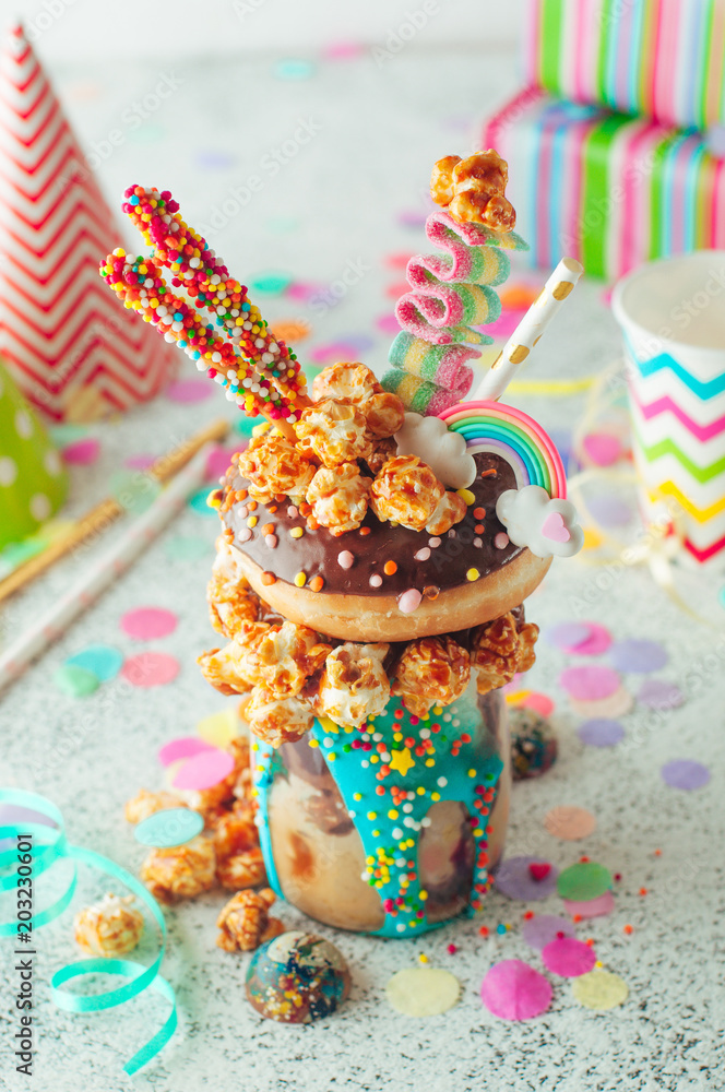 Naklejka premium Chocolate freak shake with donut on the party table