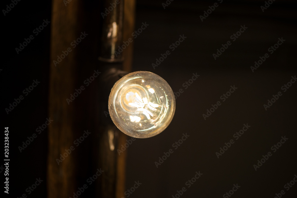 A bright bulb in the middle of the night hung on a ceiling A bright bulb in the middle of the night hung on a ceiling