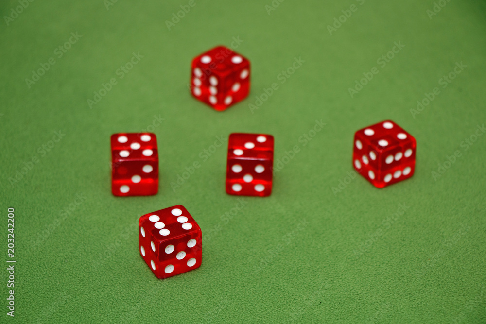 Dices on a green velvet table. Dices on a green velvet table.