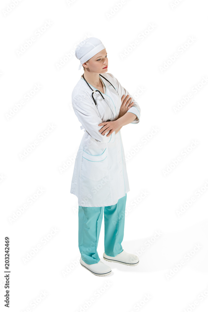 Beautiful young woman is standing seriously in white coat posing at studio. Full length studio shot isolated on white. Beautiful young woman is standing seriously in white coat posing at studio. Full length studio shot isolated on white.