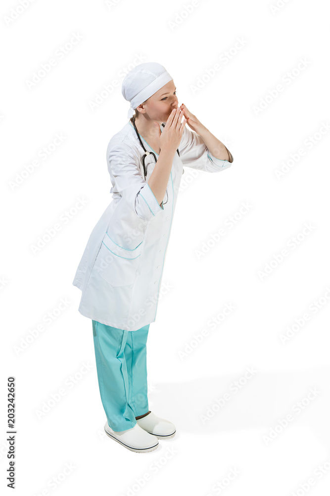 Beautiful young woman is sending an air kiss in white coat posing at studio. Full length studio shot isolated on white. Beautiful young woman is sending an air kiss in white coat posing at studio. Full length studio shot isolated on white.