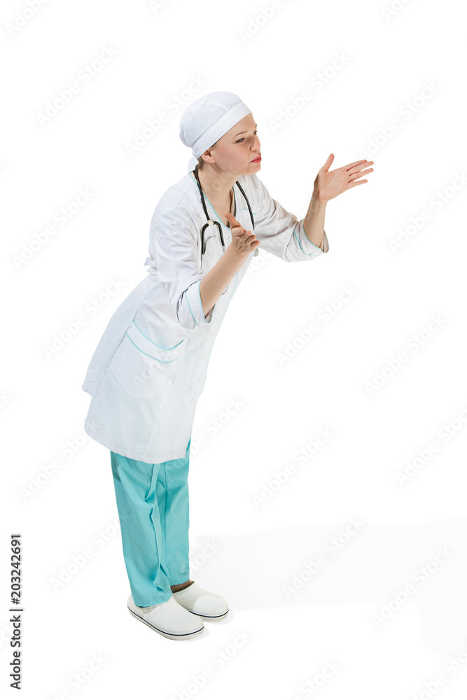 Beautiful young woman is sending an air kiss in white coat posing at studio. Full length studio shot isolated on white. Beautiful young woman is sending an air kiss in white coat posing at studio. Full length studio shot isolated on white.