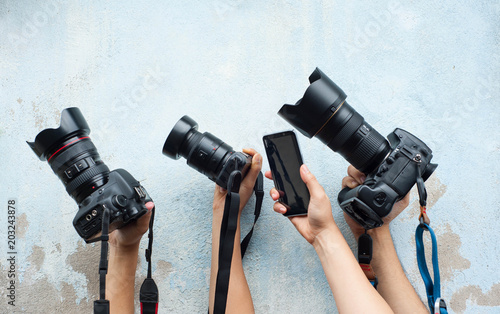 Technology of camera,Development of camera,various camera on the blue wall,Hold hands with favorite camera