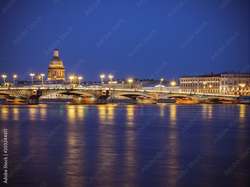 Blagoveschensky or Annunciation Bridge and Saint Isaac Cathedral at night. Saint-Petersburg, Russia