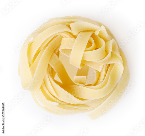 Uncooked nest of tagliatelle pasta isolated on white background with clipping path