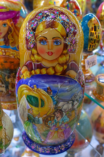 Souvenir dolls on the shelf for sale. Russian Matryoshka Nesting Dolls Set in Classic Clothes at Gift Shop Shelf.  Souvenir from Russia. © Maryana