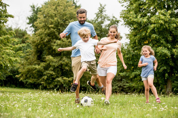 Family playing soccer