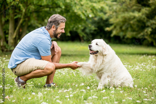 Man training dog in the park photo