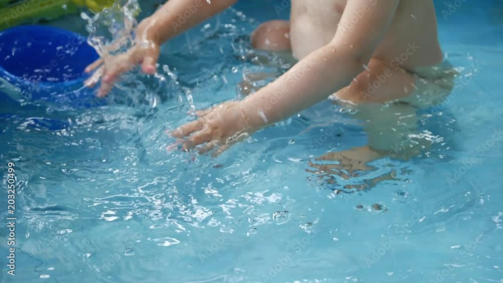 slow motion child playing water in baby inflatable pool slow motion child playing water in baby inflatable pool