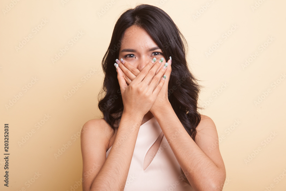 Beautiful young Asian woman close her mouth. Beautiful young Asian woman close her mouth.