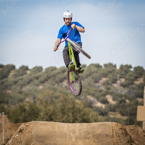 Sportsman flying on a bike in nature photo