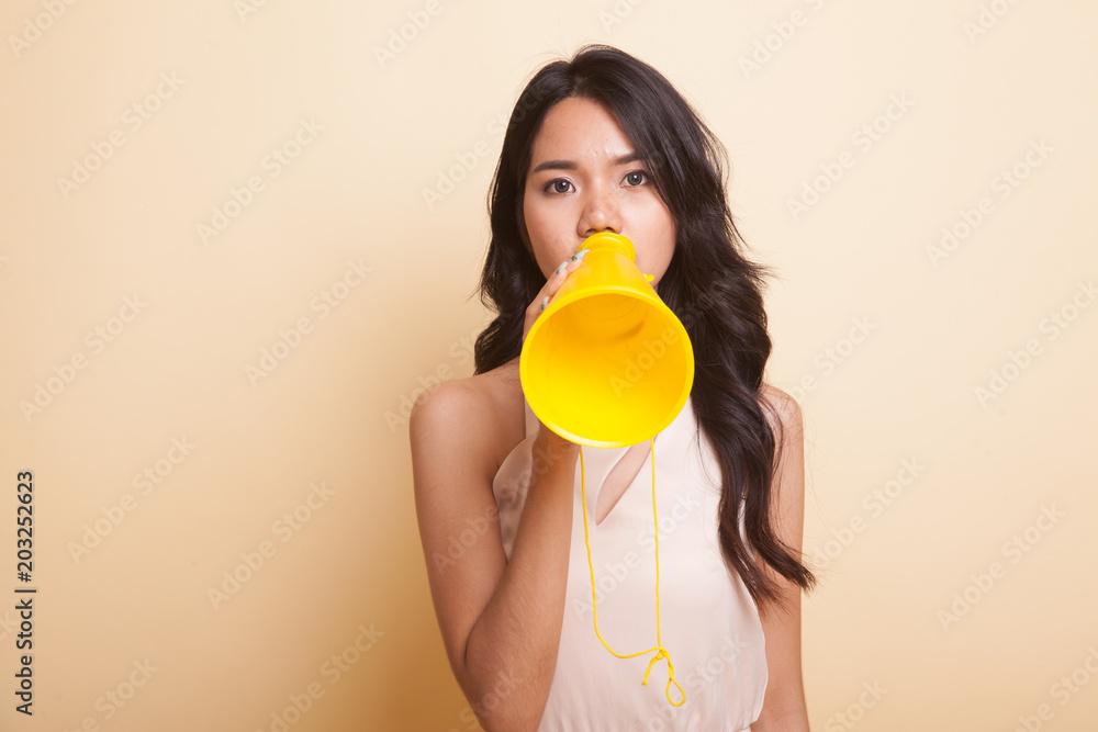 Beautiful young Asian woman announce with megaphone. Beautiful young Asian woman announce with megaphone.
