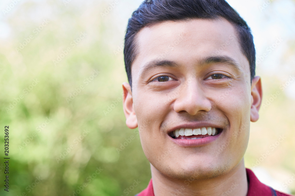 Outdoor Head And Shoulders Portrait Of Smiling Young Man Outdoor Head And Shoulders Portrait Of Smiling Young Man