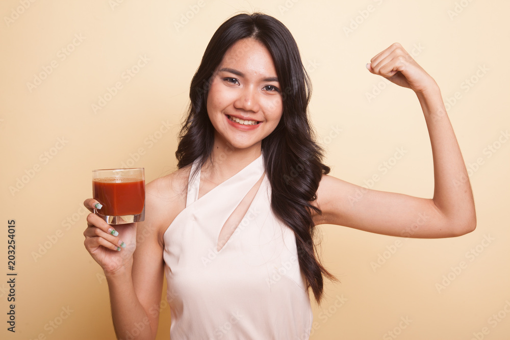 Strong healthy Asian woman with tomato juice. Strong healthy Asian woman with tomato juice.