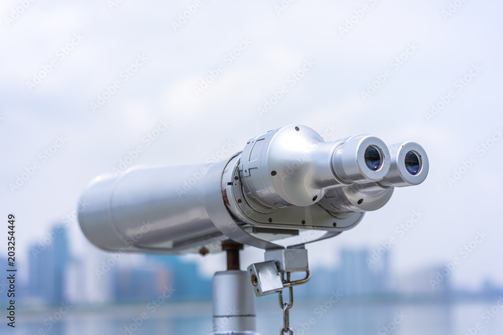 telescope with city skyline