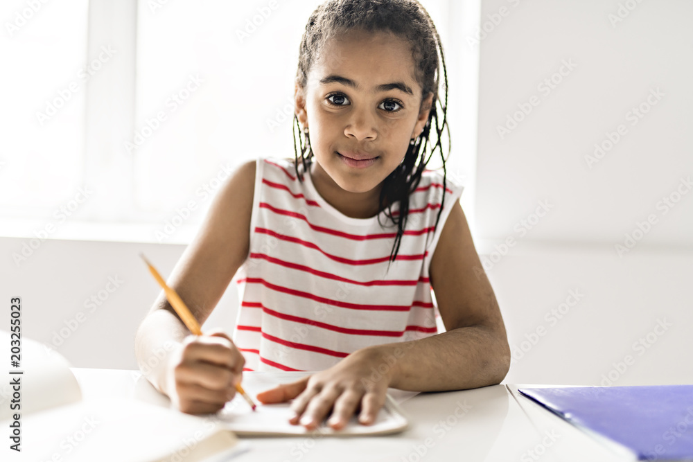 Black girl doing homework at home Black girl doing homework at home