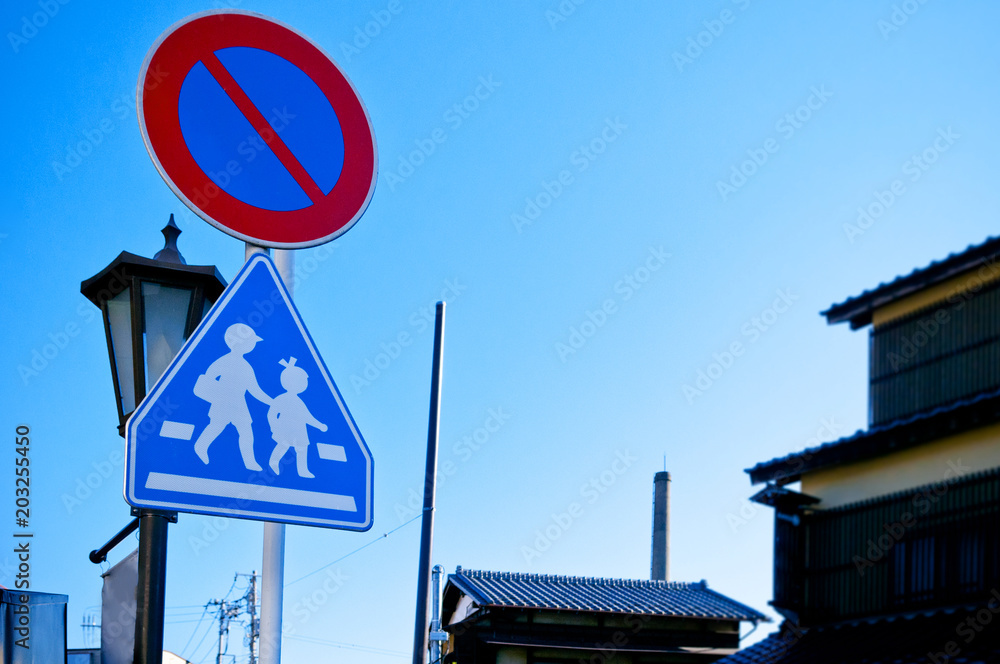 Obraz premium Pedestrian crossing street sign and stop sign, Narita, Chiba, Japan