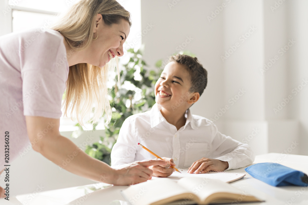 mother help Black boy doing homework at home mother help Black boy doing homework at home