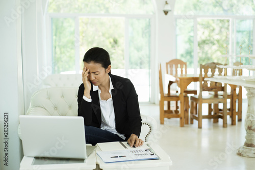  woman having an headache at office