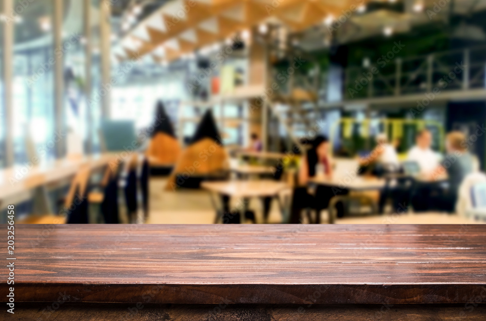 Selected focus empty brown wooden table and Coffee shop or restaurant blur background with bokeh image. for your photomontage or product display. Selected focus empty brown wooden table and Coffee shop or restaurant blur background with bokeh image. for your photomontage or product display.