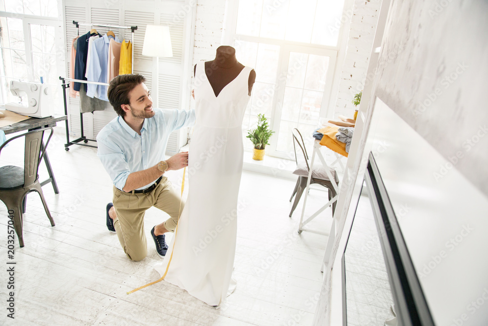 My creation. Inspired bearded dressmaker smiling and making a new dress