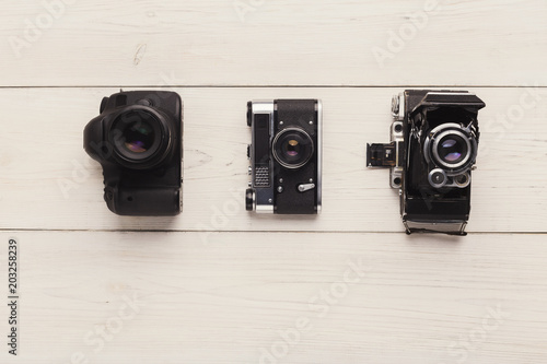 Three different cameras on white table