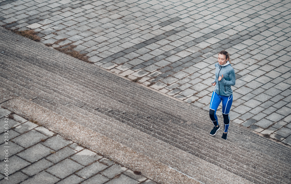 Girl jogging. Young woman exercising, outside