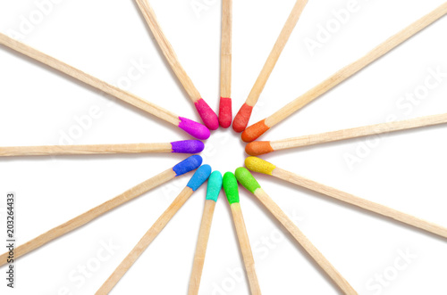 Rainbow colored matches isolated on white, diversity concept