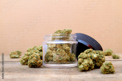 Fototapeta Marijuana in Open Jar Surrounded by Buds - Centered (Green Crack, Sativa Dominan