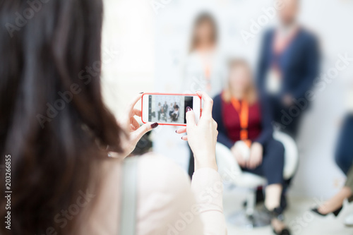 woman taking pictures with her smart phone