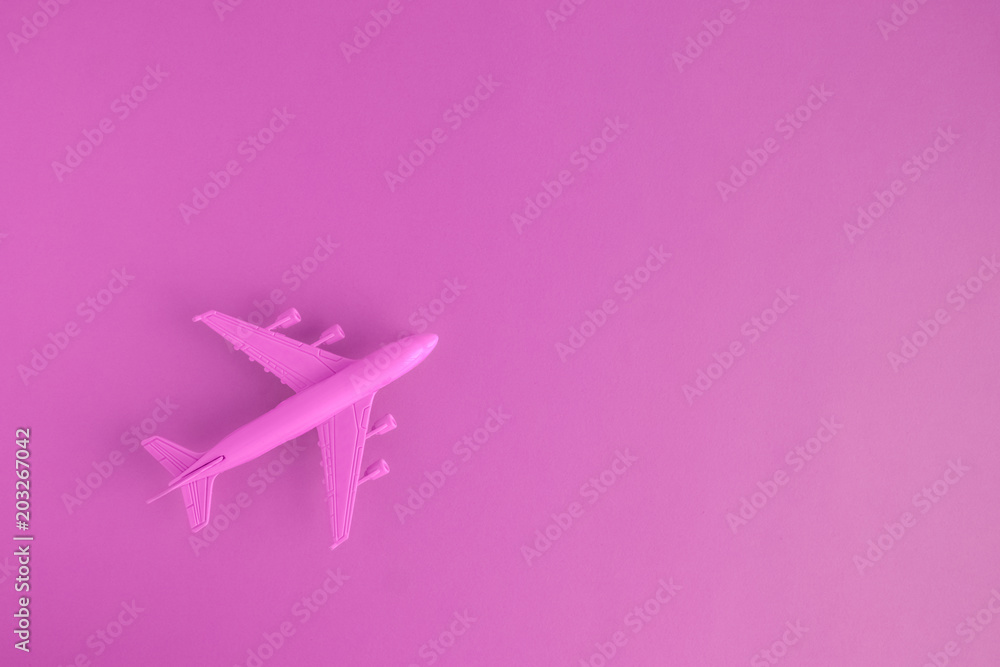 High angle view of model commercial plane rose color concept.
