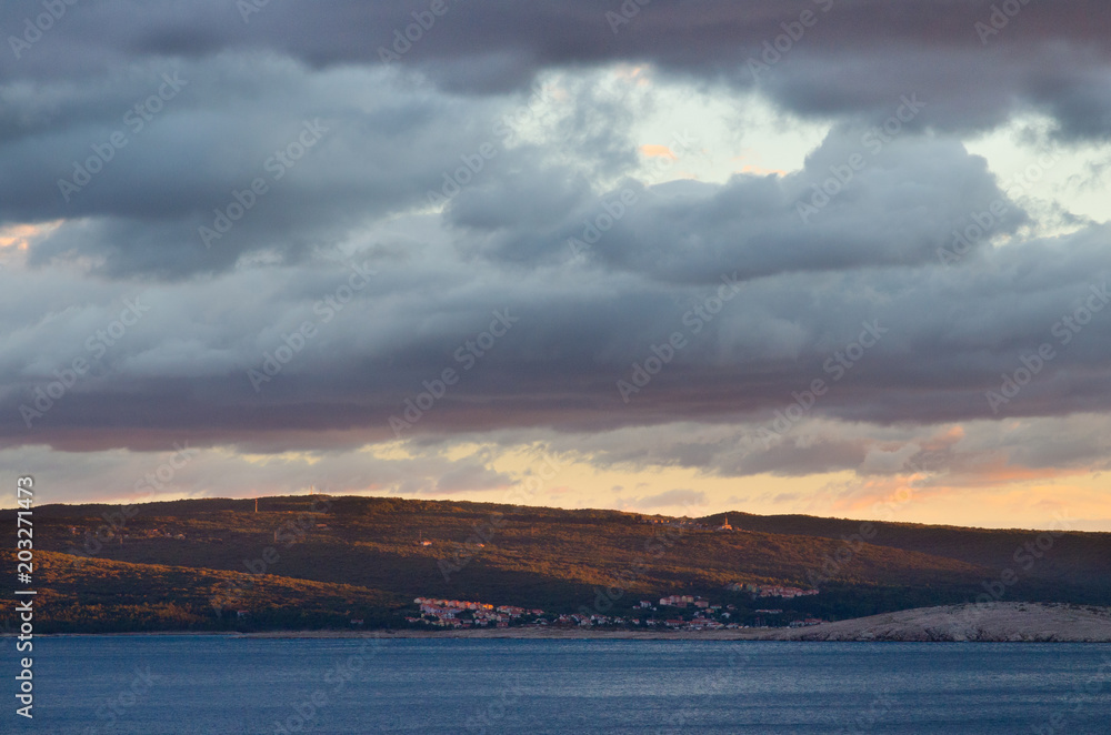Dark clouds at sunset over a landscape on the coast of Croatia Dark clouds at sunset over a landscape on the coast of Croatia