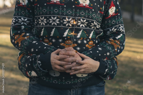 Hands of boy and girl with Christmas clothes