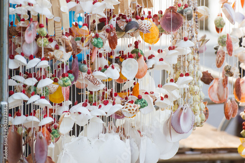 close up Hanging decor by sea shells at street shops, product hand made, decoration at home 