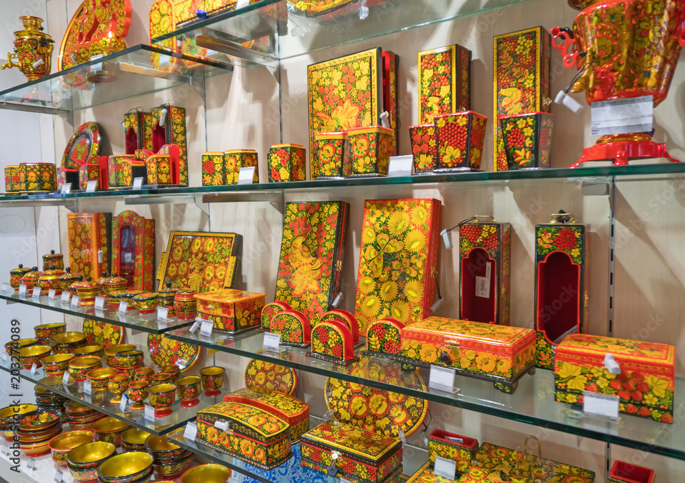 Khokhloma painting on tableware in the shop.