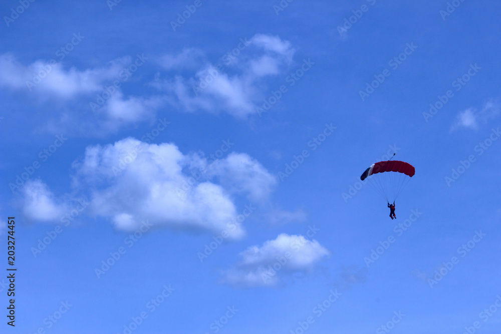 Skydiver In Blue Sky. Active Hobby.Skydiving.Abstract Nature Background. Skydiver In Blue Sky. Active Hobby.Skydiving.Abstract Nature Background.