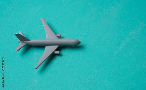 Gray Miniature toy airplane on blue background