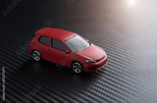 Red miniature car on carbon kevlar
