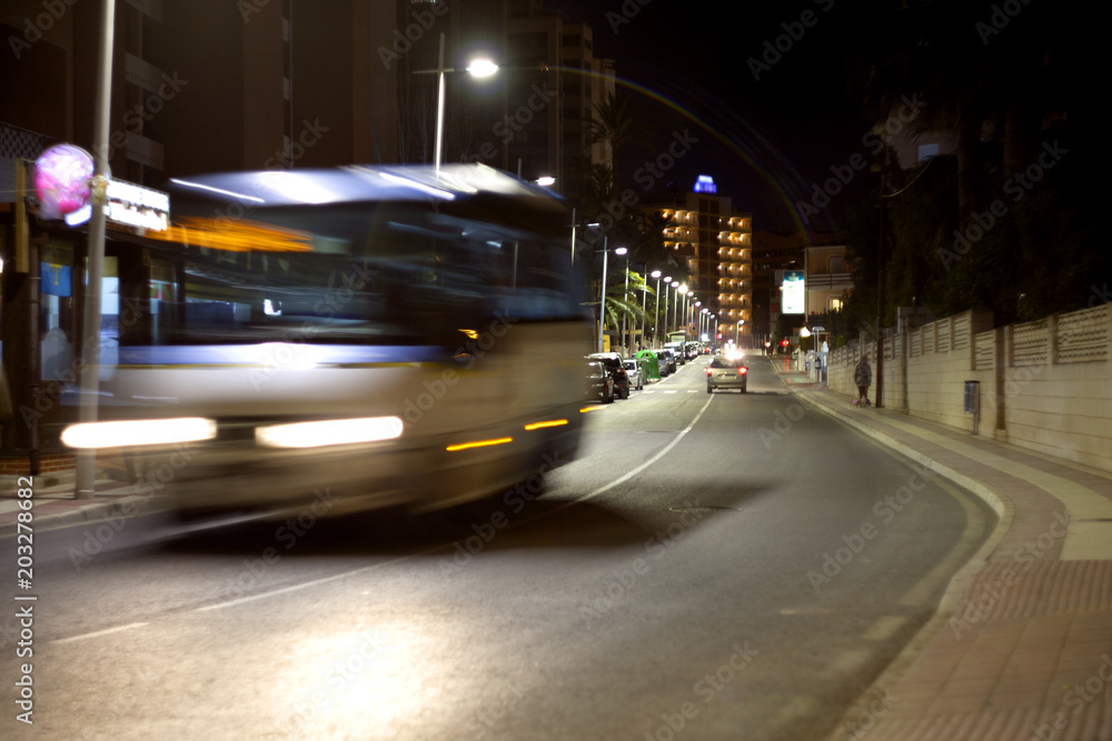 Bus on the night street. Blurred motion.