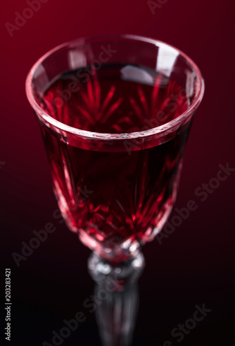 Close-up of crystal glass with red wine.